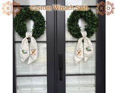 two wreaths are hanging on the glass doors