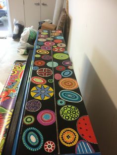 the long table is decorated with brightly colored circles and designs on black fabric, along with white walls