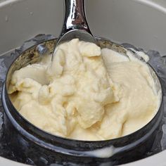 a spoon full of ice cream in a bowl