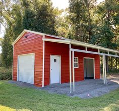 a red two story garage with an attached carport