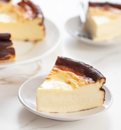 two plates with slices of cheesecake on them