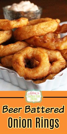 beer battered onion rings with ranch dip in the background and text overlay that says beer battered onion rings