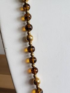 This is a vintage Napier, gold tone metal beads and glass beads necklace. There is a bit of the chain that doesn't have beads on it, as you can see in images. The beads can move on the necklace, slightly. This measures 25.25 inches across. Don't forget to stop in at my other Etsy shop... http://www.etsy.com/shop/xtdesigns. Follow me on Twitter at... MyYiayiaHadThat@MyYiayiaHadThat. If you have a wish list or are looking for something specific, please ask. I may have exactly what you are looking Gold Beaded Long Necklace With Large Beads, Gold Long Beaded Necklace With Large Beads, Vintage Polished Gold Beads, Vintage Beaded Chain Necklace With Round Beads, Vintage Gold Polished Beads, Vintage Large Gold Beads, Vintage Gold Beads For Gifts, Vintage Gold Beaded Necklaces For Gifts, Vintage Gold Beads For Gift