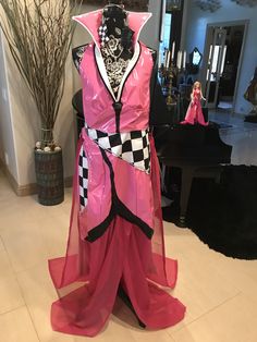 a mannequin dressed in pink and black with a checkerboard design on it