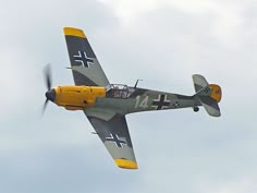 an old style airplane flying in the sky