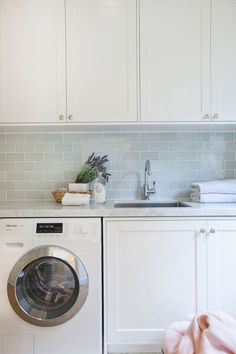 a washer and dryer in a white kitchen