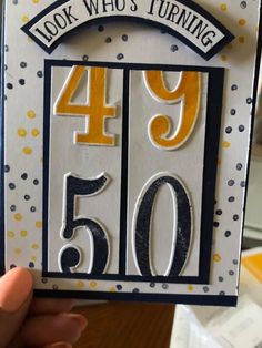 someone holding up a birthday card with the number forty fifty and four hundred years on it