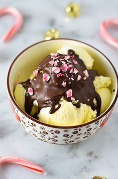 a bowl filled with ice cream covered in chocolate and sprinkles