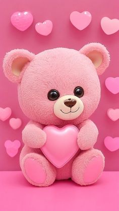 a pink teddy bear holding a heart on a pink background