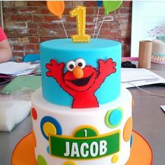 the birthday cake is decorated with an elmo theme