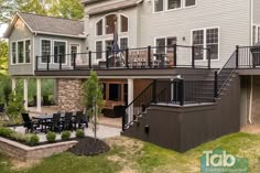 a large house with a deck and outdoor dining area