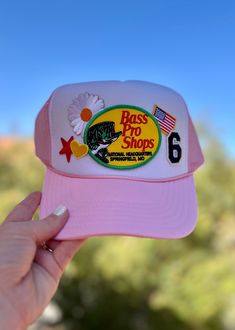 This cute trucker style hat is the perfect gift! Very unique patch style trucker hat! Snag one for you or a friend! 😊 PLEASE NOTE that the size of patches & placement may slightly differ than the hat pictured. My patches are sourced from multiple different places & may not always be exactly as shown but I do my best to keep them as close as possible  **Listing is for HAT ONLY ❤ CUSTOM: We're happy to create something custom for you! Please just send a message with your idea & we will work together to bring your idea to life! ❤ SIZE: This hat is one size unisex. It is a snapback so it is adjustable from 20"-23.5" ❤ COLOR: The color of the hat in this listing is PINK & WHITE.  ❤ PROCESSING TIME: Your product will ship within 7-14 business days after purchase. But please note this does not i Spring Trucker Hat With Curved Brim, Spring Trucker Hat With Flat Brim, Cute Trucker Hat With Flat Brim, Pink 5-panel Trucker Hat For Spring, Pink Flat Brim Trucker Hat For Outdoor, Flat Brim Hats With Logo Patch For Spring, Casual Pink Hats With Logo Patch, Pink Trucker Hat For Baseball Season With Curved Brim, Trucker Snapback Hat With Curved Brim And Patches