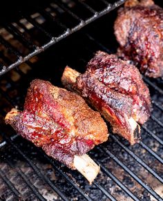 two steaks are cooking on the grill