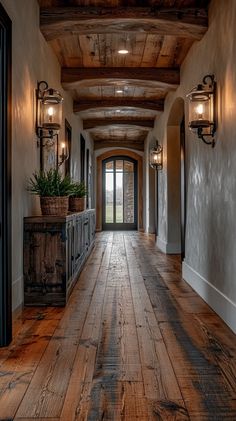 a long hallway with wooden floors and lights