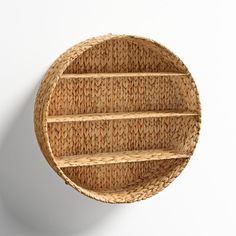 a round wicker shelf mounted on the wall