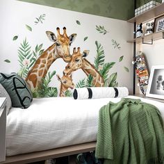 two giraffes standing next to each other on a bed in a bedroom