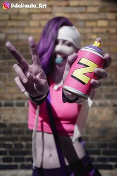 a woman with purple hair is holding a can