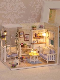 a doll house with furniture and flowers in it