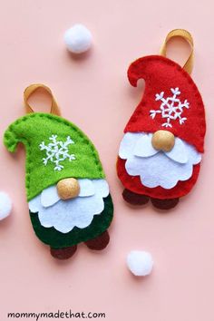 two felt christmas gnomes with snowflakes on them