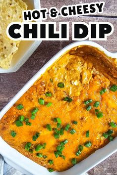 A freshly baked hot and cheesy chili dip in a white dish, topped with melted cheddar cheese and chopped green onions, served with tortilla chips on the side—perfect for easy finger food ideas.