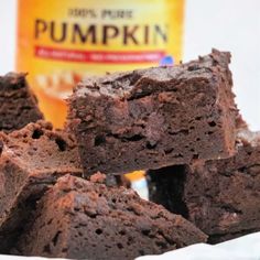 brownies stacked on top of each other in front of a bottle of pumpkin syrup