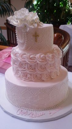 a three tiered wedding cake with white flowers on top