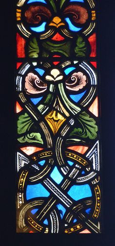 a stained glass window in the shape of a bird with two eyes and an elaborate design