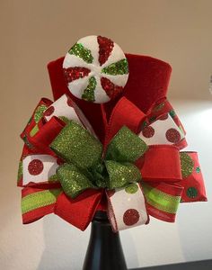 a red and green christmas bow with candy canes