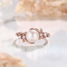 a white pearl ring with leaves on it