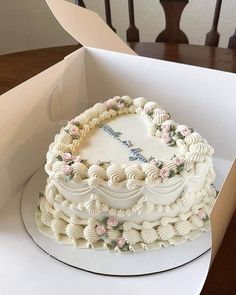 a heart shaped cake in a box on a table