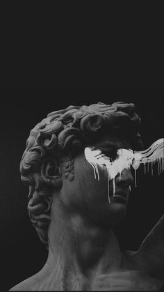 a black and white photo of a statue with icing on it's face