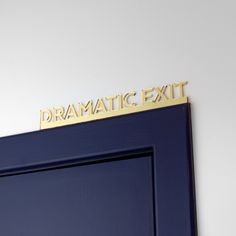 a blue door with the words dramatic exit written on it's side and gold lettering