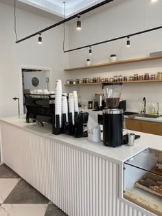 a coffee shop with lots of counter space and appliances on the counters, along with other items