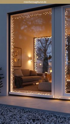 a living room with christmas lights on the windows