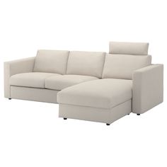 a white couch with a chaise lounger on the bottom right side and an ottoman in the middle