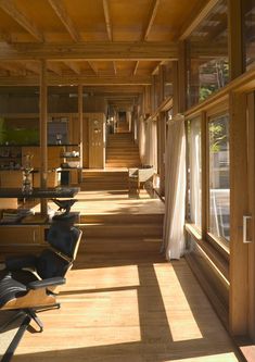 the sun shines through the windows in an empty room with chairs and desks