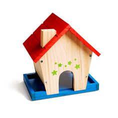 a small wooden bird house with red roof