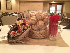 baseballs and candy in a jar on a table