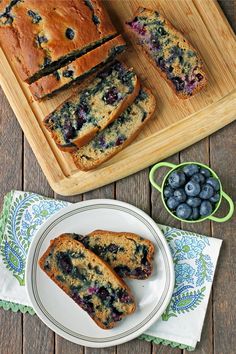 slices of blueberry bread on a plate next to a bowl of fresh blueberries