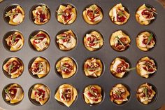 many small appetizers are being prepared in a muffin tin