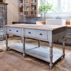 an old kitchen island with drawers in the center