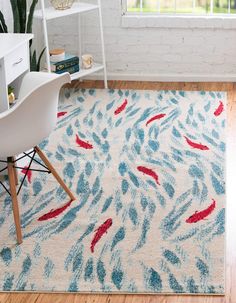 a white rug with blue and red designs on it in front of a window next to a chair