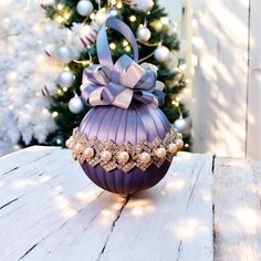 Add a touch of serene elegance to your holiday decor with this exquisite round Christmas ornament, wrapped in a soft dusty blue satin ribbon. The gentle blue hue creates a tranquil, winter-inspired look, providing a unique, refined backdrop that complements both traditional and contemporary holiday themes. Encircling the ornament are alternating pearl and rhinestone accents, creating a sophisticated ring of sparkle and grace. The lustrous pearls offer a classic touch, while the rhinestones catch the light, adding a delicate shimmer that brings the ornament to life. This continuous band of pearl and rhinestone accents adds a touch of luxury, beautifully contrasting with the soft, cool blue satin. Ideal for those who appreciate timeless decor with a hint of glamour, this ornament is perfect Xmas Balls, Fairy Christmas, Girly Christmas, Bows Diy Ribbon, Bows Diy, Winter Inspired, Timeless Decor