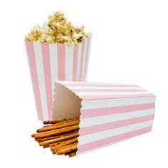 a pink and white striped popcorn box with crackers sticking out of it's side