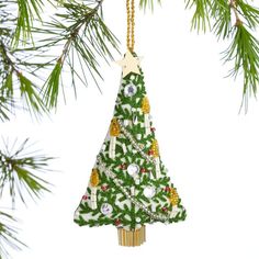 a green christmas tree ornament hanging from a pine tree with white and gold decorations