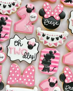 minnie mouse cookies are decorated with pink and white icing for the first birthday girl