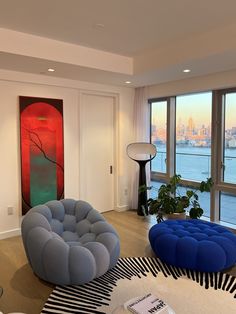 a living room filled with furniture and large windows