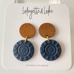 Handmade polymer clay wooden stud with navy circle medallion earrings--perfect for work and play! The wood circle stud measures half an inch and the entire earring is 1.4 inches. At it's widest, the earrings are .75 inches.  Each pair of earrings is one-of-a-kind, made by me, so any slight imperfections or variances make them unique. There also could be small air bubbles, scratches, and may slightly differ from the picture you see here. Polymer clay is lightweight, durable and can last a long time with proper care: * Remove before showering, swimming, exercising, and bedtime * Allow lotions and perfumes to dry before wearing * Store away from direct sunlight * To clean your earrings use a damp cloth and wipe gently. I do not offer refunds or exchanges due to hygiene reasons. Please notify Medallion Earrings, Wear Store, Wood Circles, Circle Studs, Air Bubbles, Heart Studs, Etsy Earrings Dangle, Heart Earrings Studs, Air Dry Clay