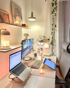 two laptops and a desktop computer on a desk