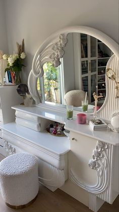 a white vanity and stool in a room